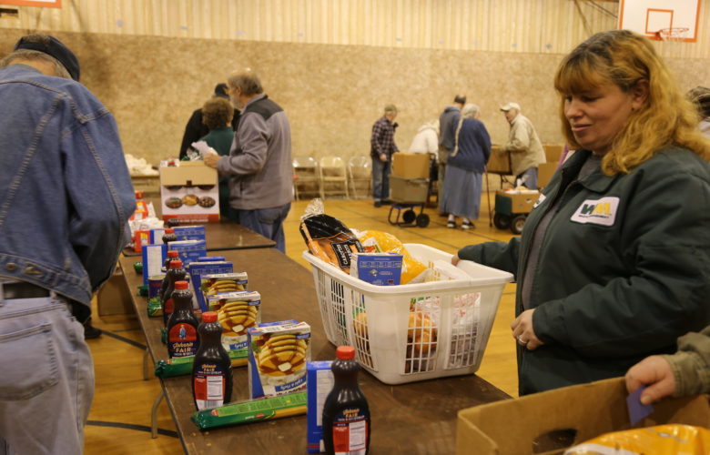 Volunteers assist in distributing mostly shelf-stable items at a food pantry in Fayette County. (Photo by Virginia Alvino Young/90.5 WESA)