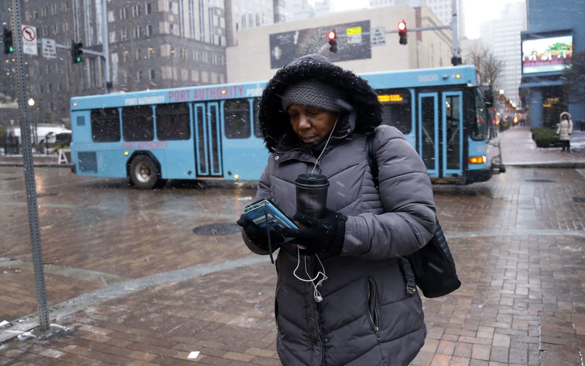 Alandia Heard waits for a bus downtown on the morning of Nov. 28. (Photo by Ryan Loew/PublicSource)