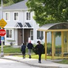 People walk along Johnston Avenue in Glen Hazel, near townhomes owned by an affiliate of the Housing Authority of the City of Pittsburgh. (Photo by Ryan Loew/PublicSource)