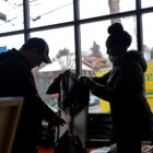 Nadine Masagara-Taylor, executive director of The Corner, assesses the damage to the community center from a Jan. 12 fire with a restoration specialist. (Photo by Jay Manning/PublicSource)