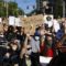 Protesters pause on Arlington Avenue en route to Downtown Pittsburgh in June 2020. (Photo by Ryan Loew/PublicSource)