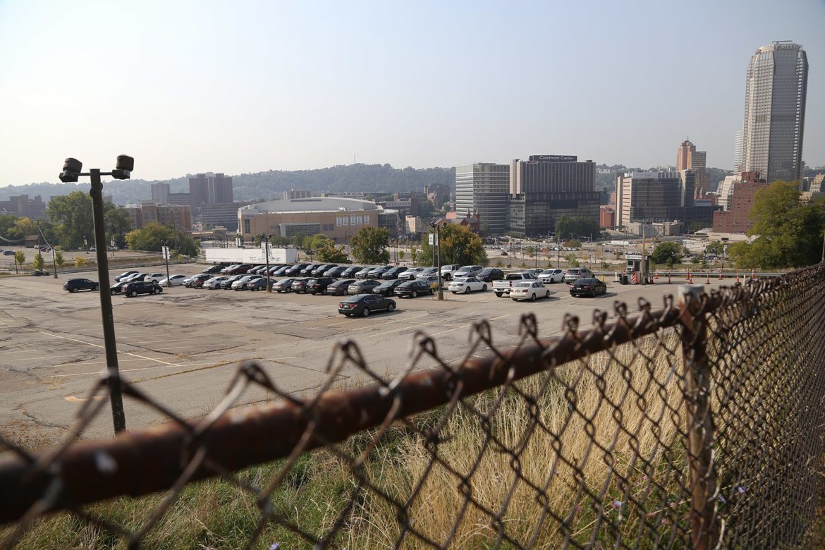 Now a parking lot, the future of the 28-acre site of the former Civic Arena continues to be a bone of contention between the Pittsburgh Penguins' development team, and the Hill Community Development Corp. (Photo by Ryan Loew/PublicSource)