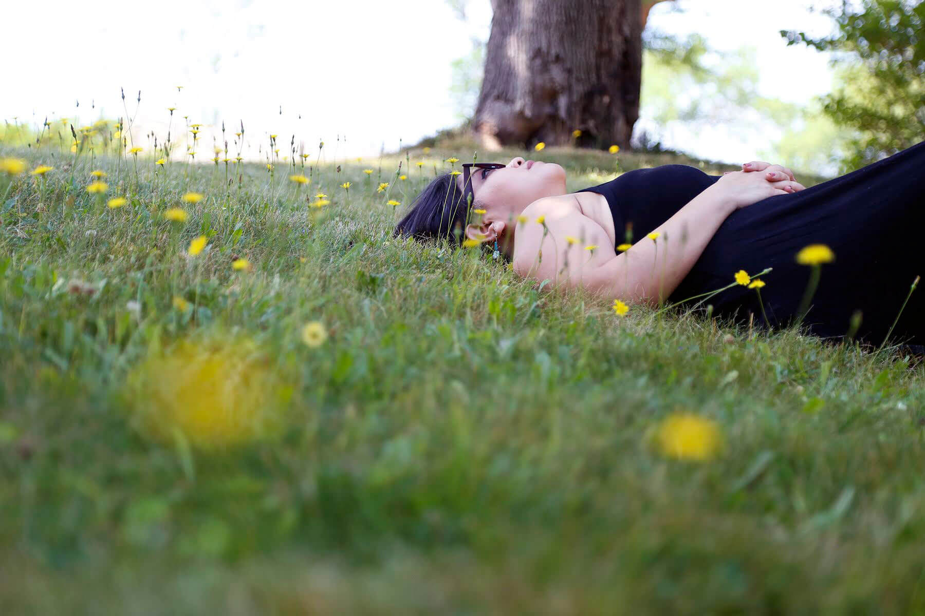 Fran Flaherty lies in the grass outside her Hampton Township home.