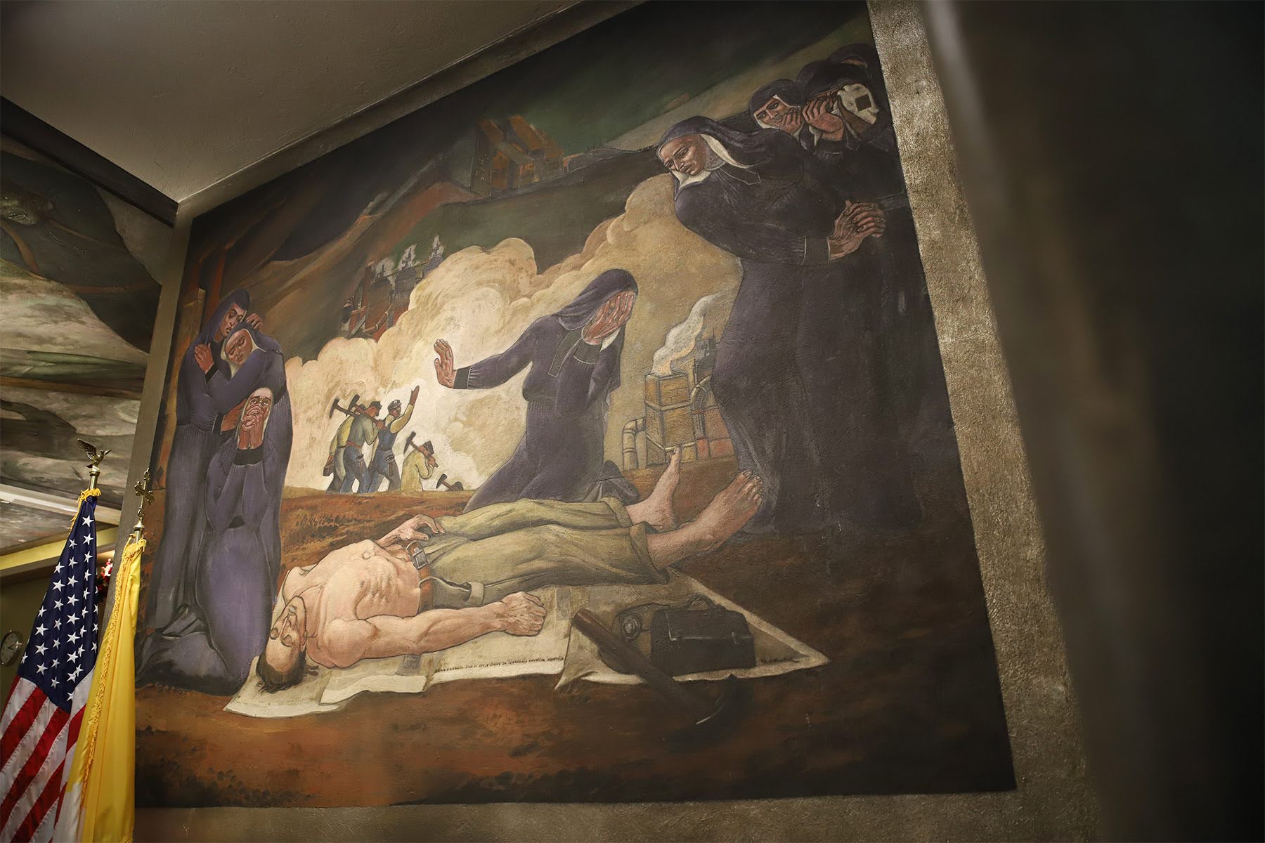 Why are there images of war on the wall of a Catholic church in