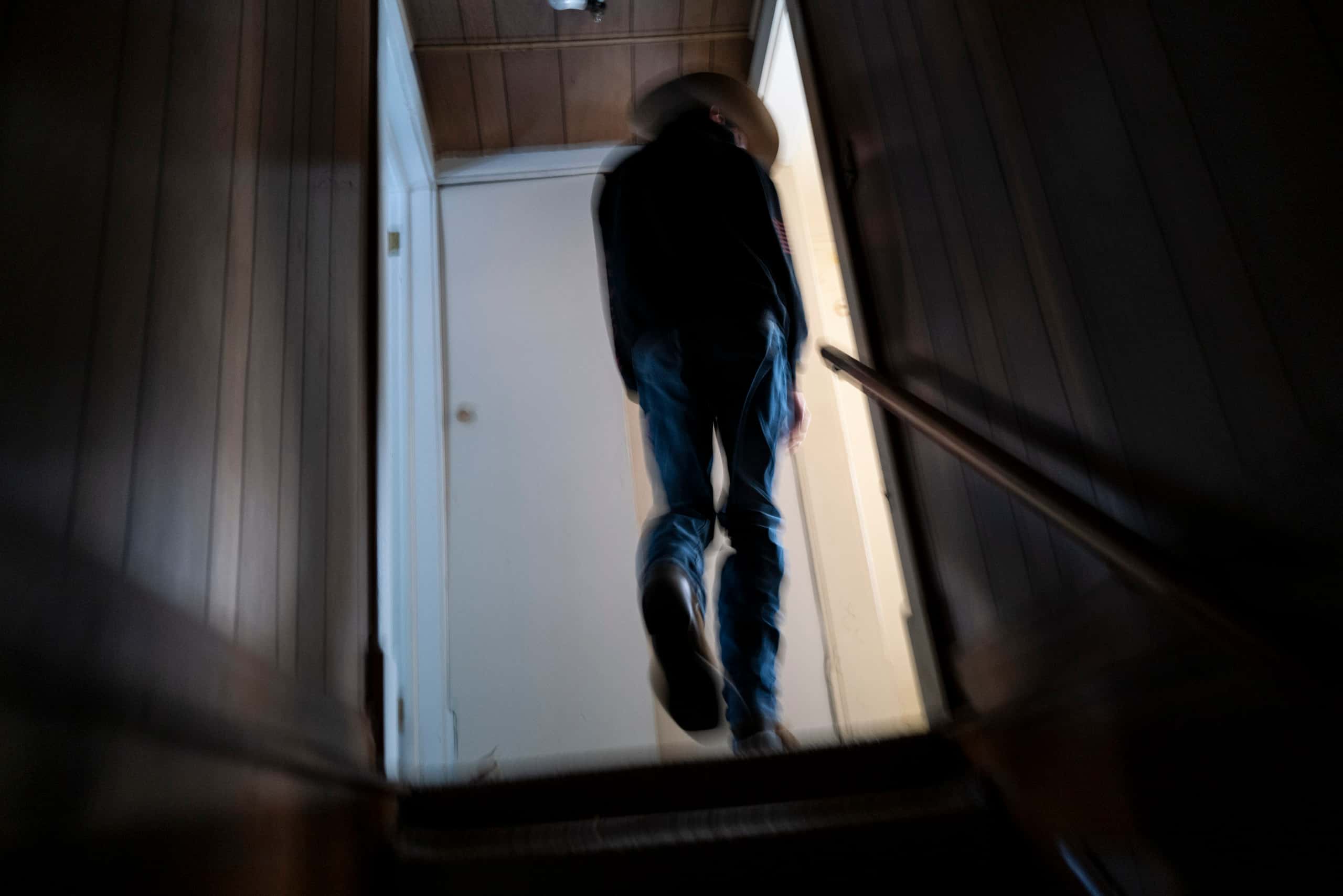 A blurred image of a boy walking up stairs.
