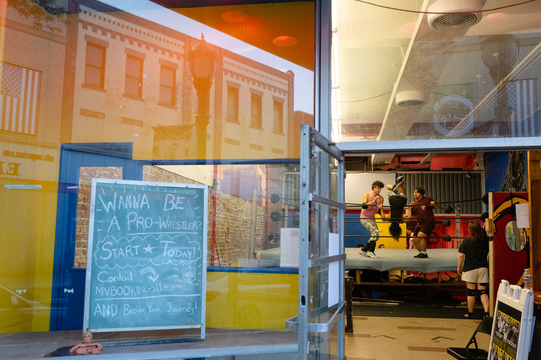 A chalkboard sign outside a gym reads,