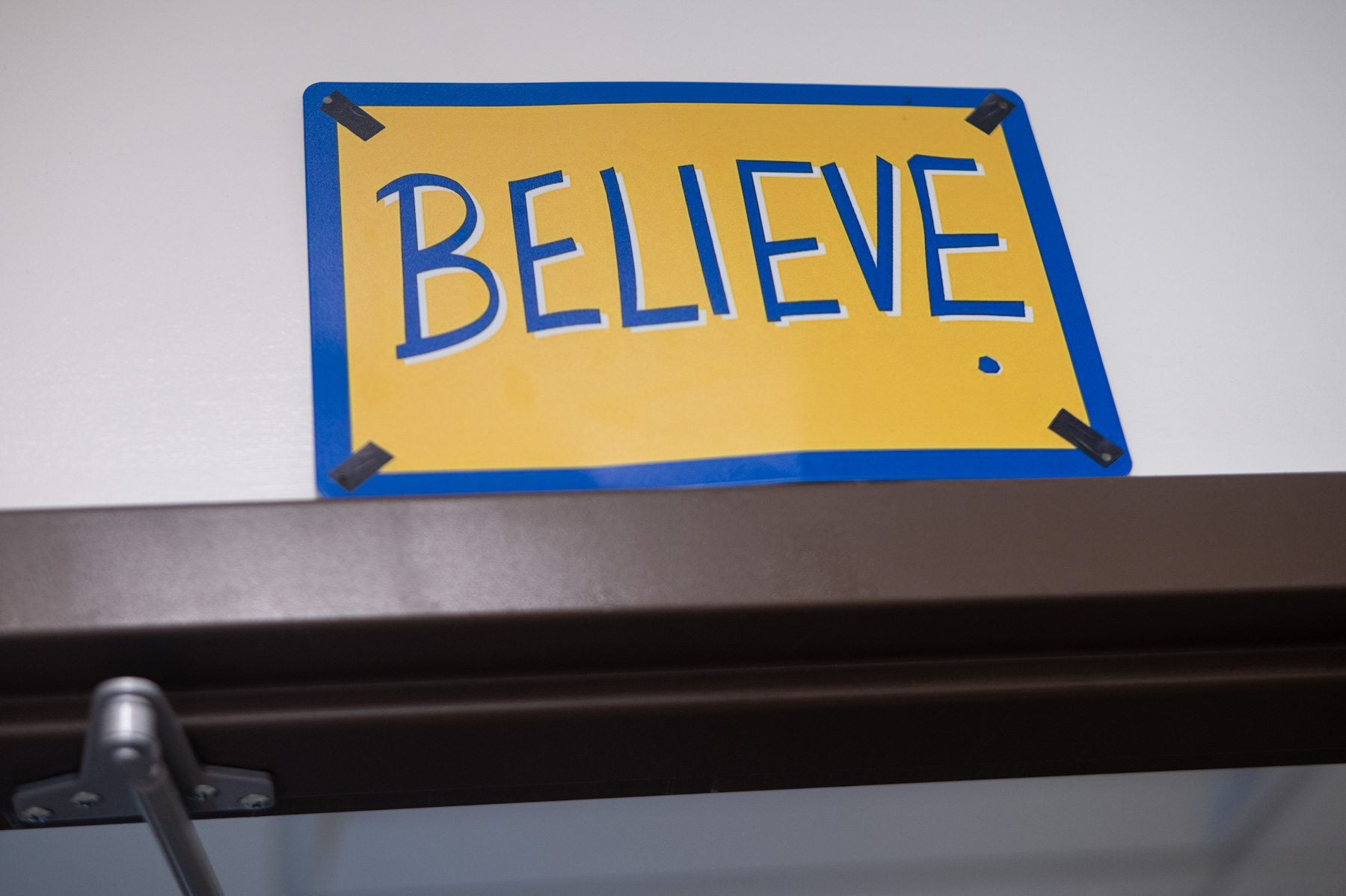 A yellow sign with blue border and the word 